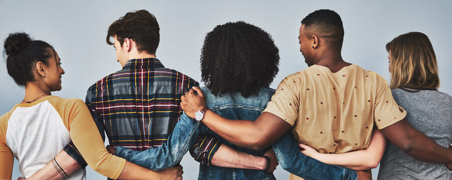 Fünf Jugendliche stehen in einer Reihe und umarmen sich - Rückansicht