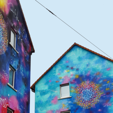 Zwei bemalte Häuserwände mit bunten Farben ohne konkretes Motiv