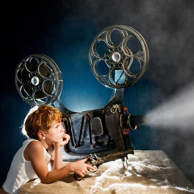 Little boy with a film projector