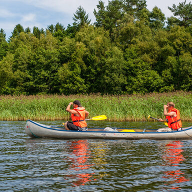 Two men in a canoe looking