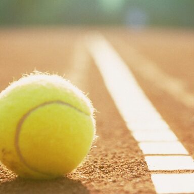 Tennis ball to corner red ground field line close up